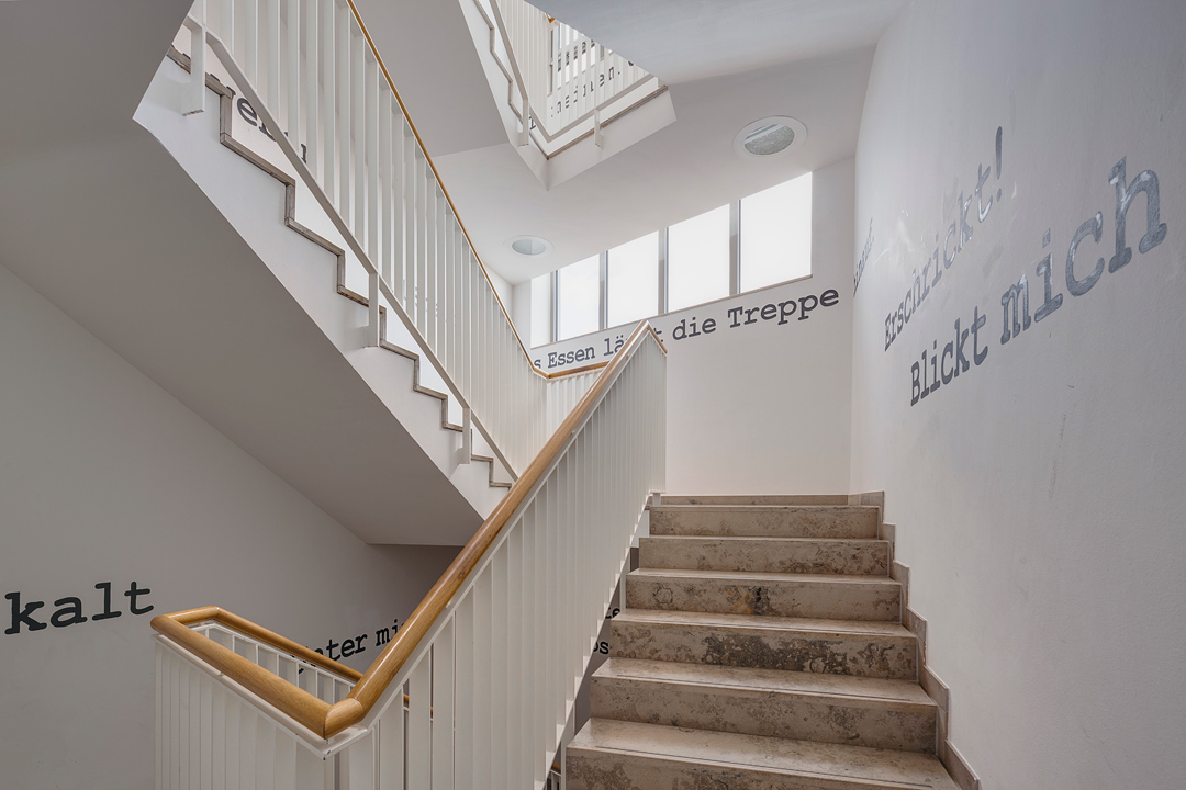 Ein sonnendurchflutetes Treppenhaus im Hochschulgebäude.