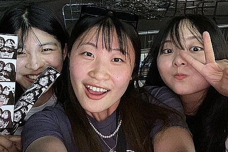 Minami and her friends looking into the camera